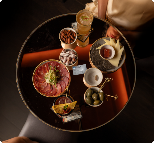 Overhead view of gourmet plated dishes served on a dark restaurant table