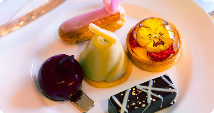 Gourmet plated dessert with fruit and sauce at a fine dining restaurant