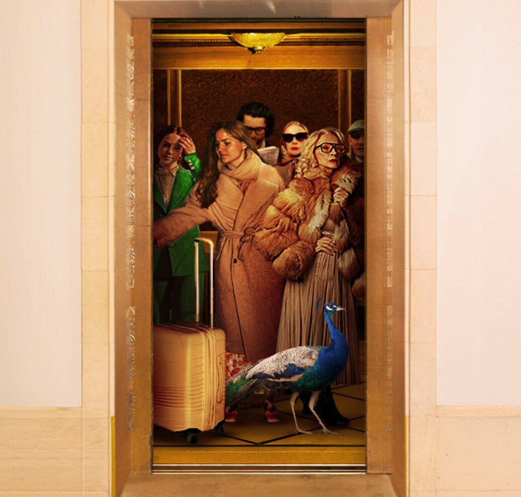 Group of fashionably dressed people and a peacock standing in a luxurious golden elevator with a light-colored suitcase.