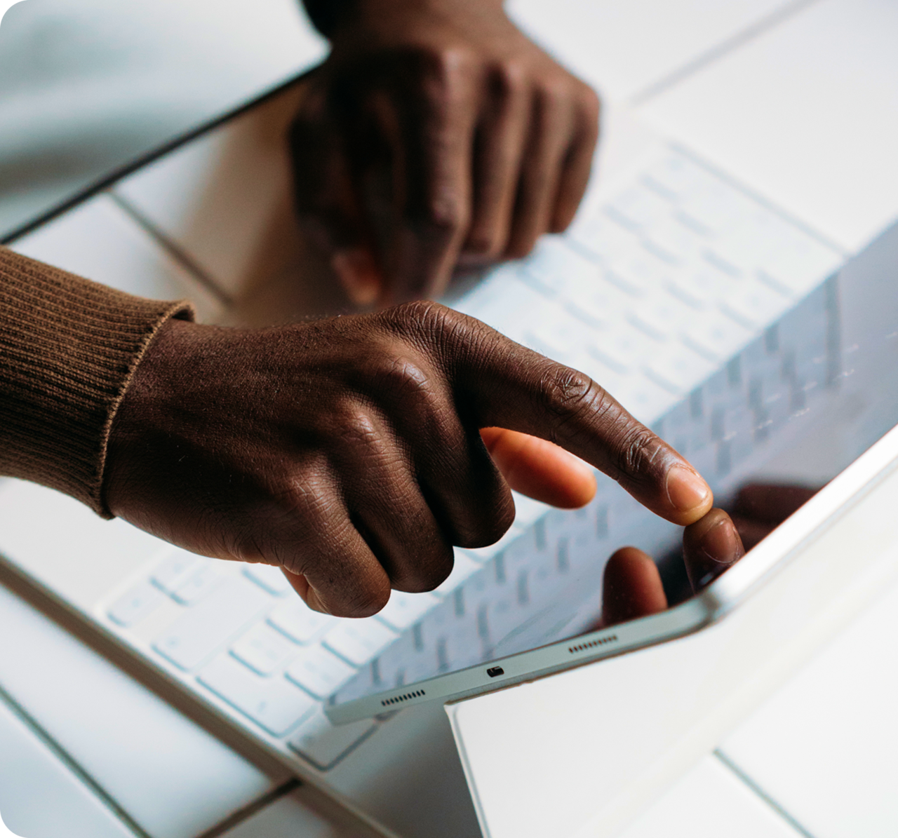 Person pointing at an open laptop