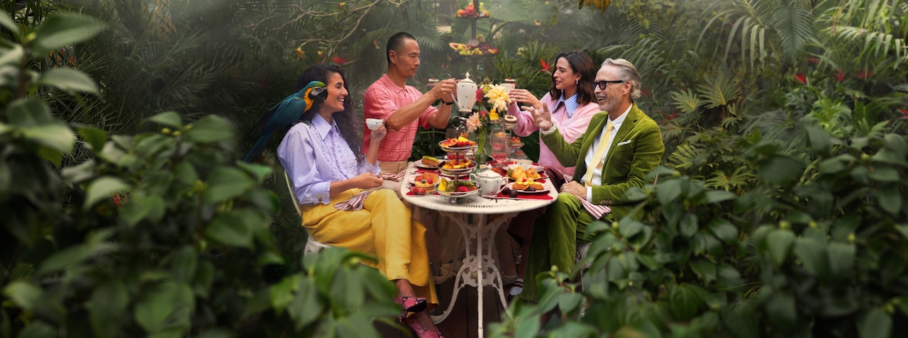 Group enjoying an outdoor garden dining experience surrounded by greenery.