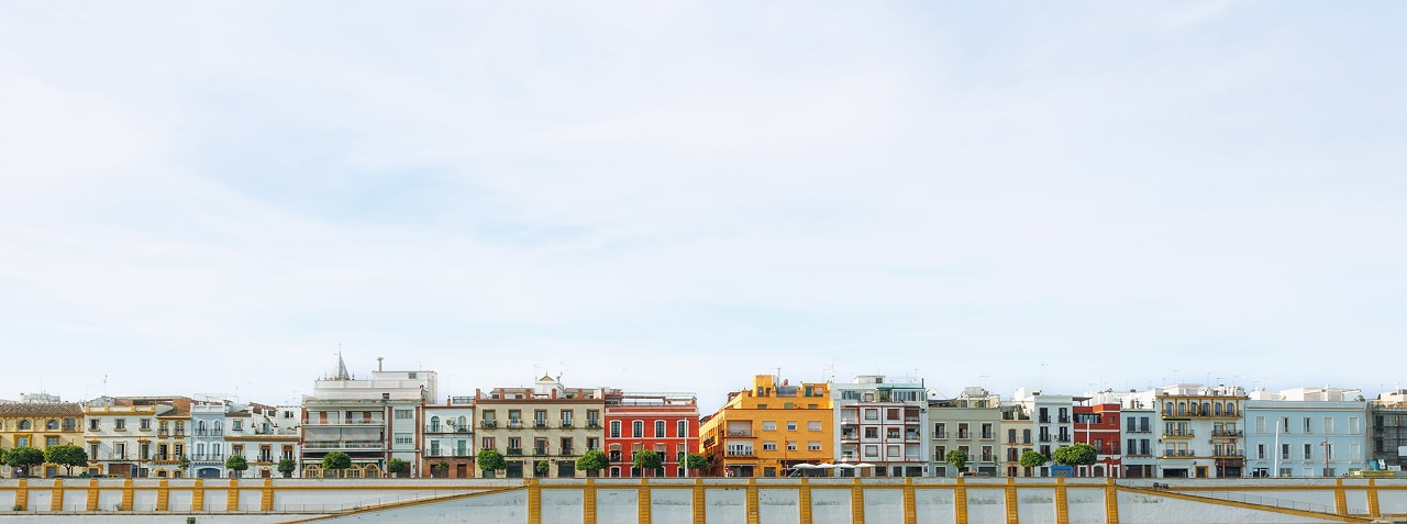 Colorful waterfront buildings along a calm seaside promenade