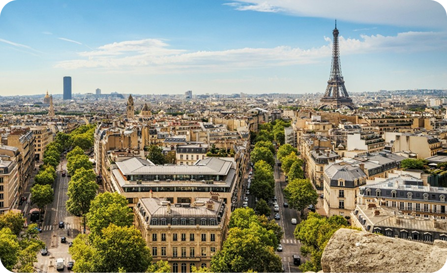 Paris cityscape with traditional buildings and the Eiffel Tower visible in the distance.