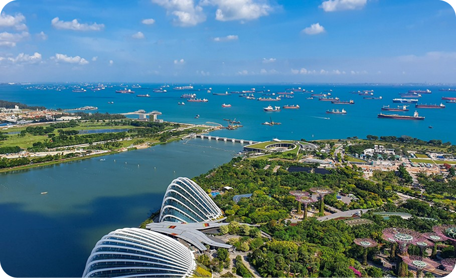 Singapore skyline with multiple glass and steel skyscrapers under a clear sky.