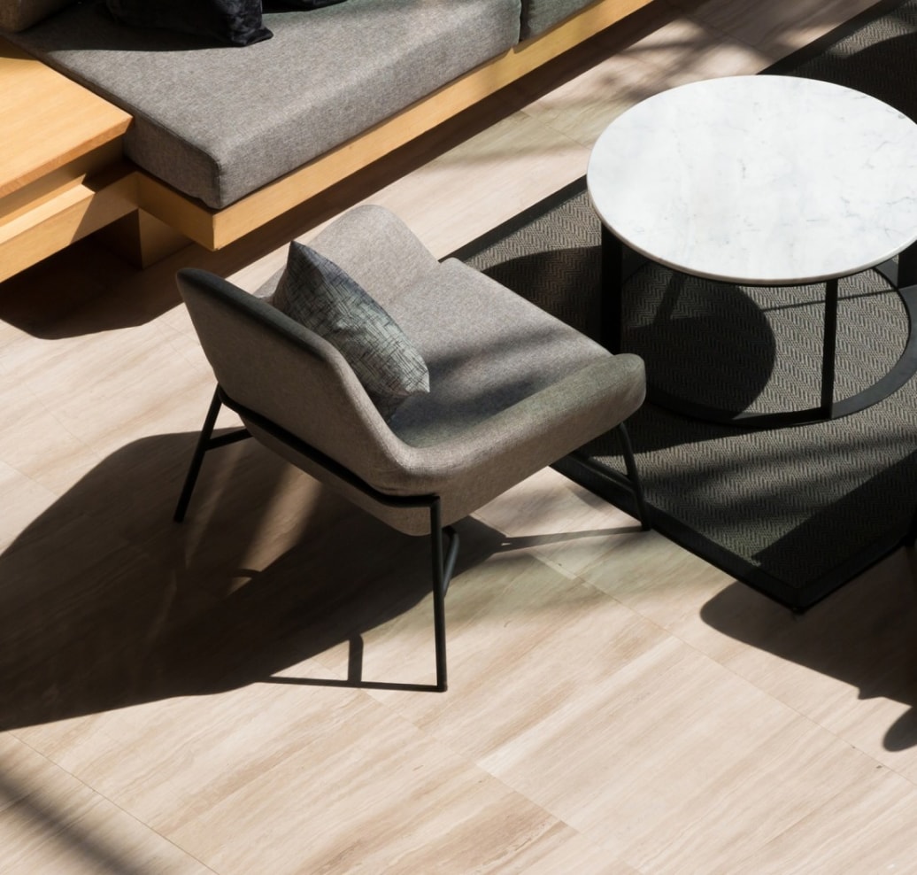 Top view of lobby lounge featuring modern grey chair and small round table.